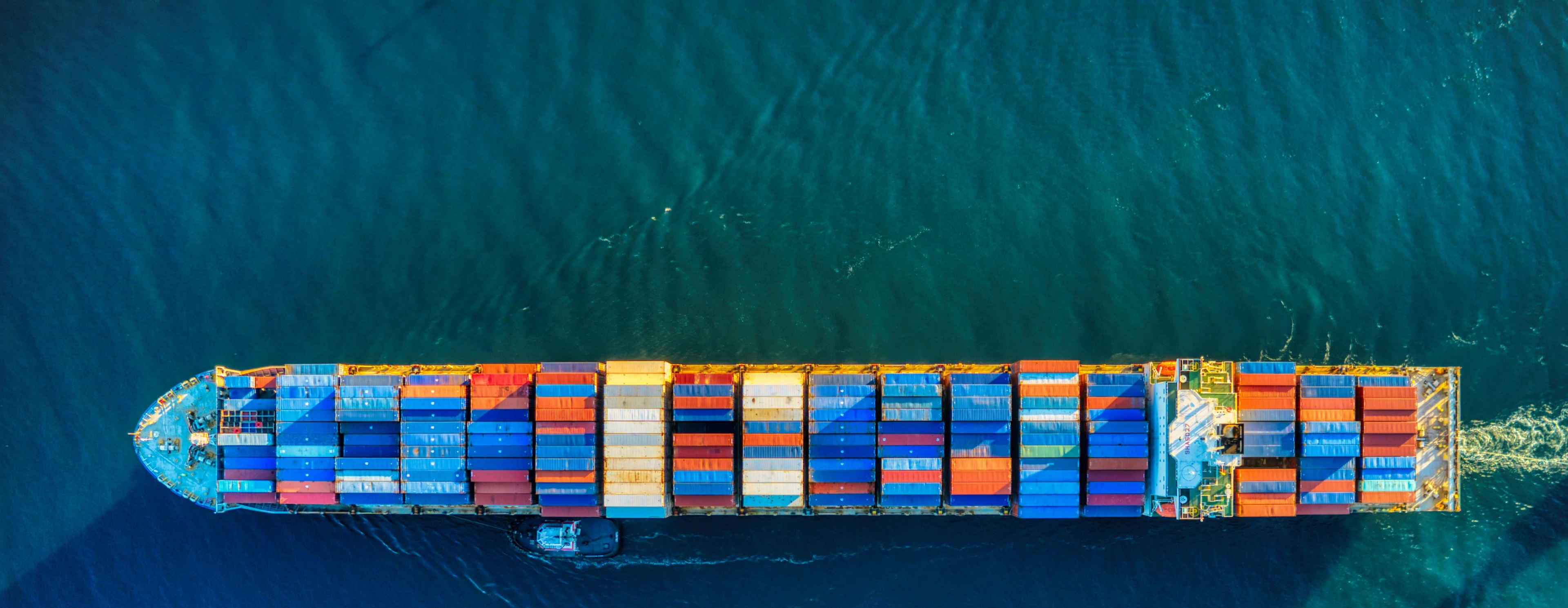 A container vessel making its way through turquoise water